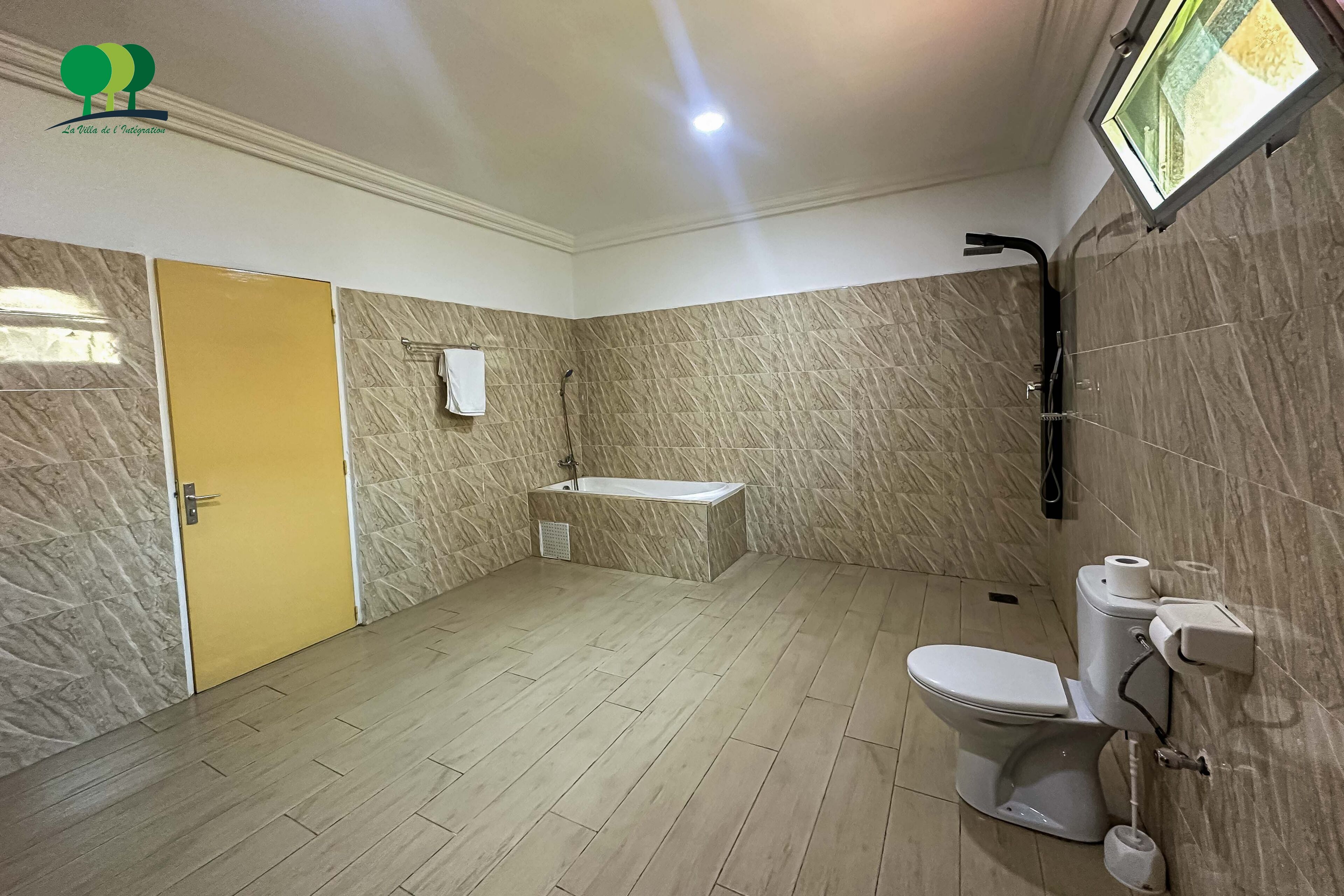 A bathroom with a bathtub, toilet, and a shower.