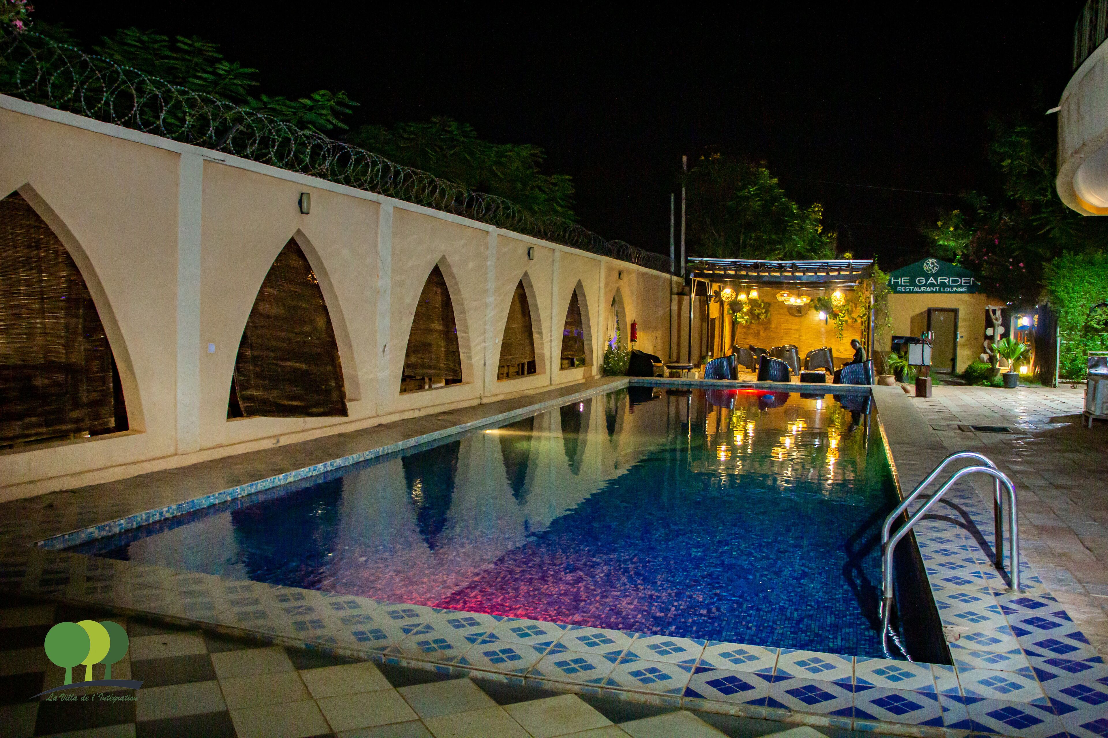 A swimming pool with a tiled edge and a metal ladder.