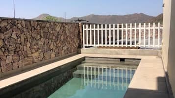 Outdoor pool, open 6:00 AM to 9:00 PM, pool loungers