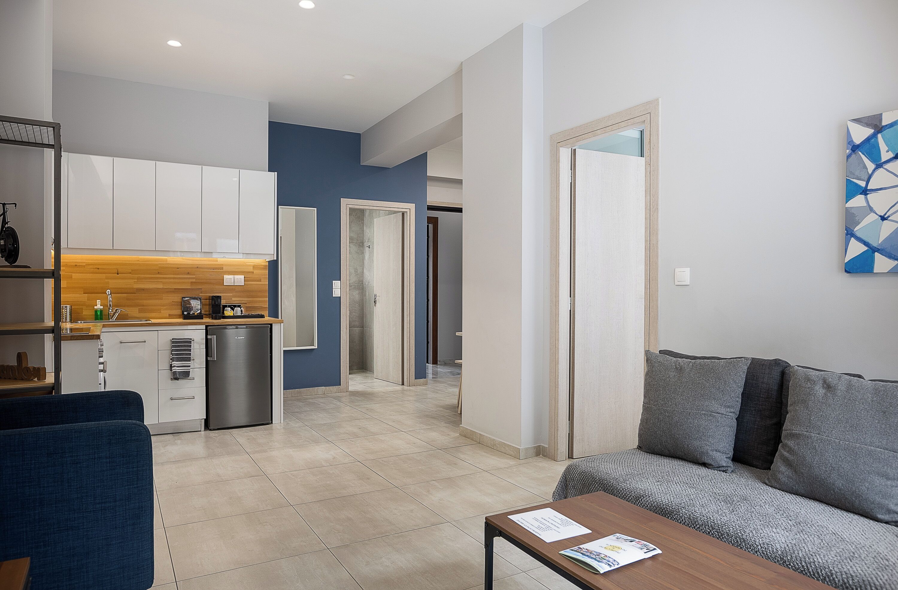 A modern apartment with a kitchen, living area, and a dining space.