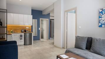 A modern apartment with a kitchen, living area, and a dining space.