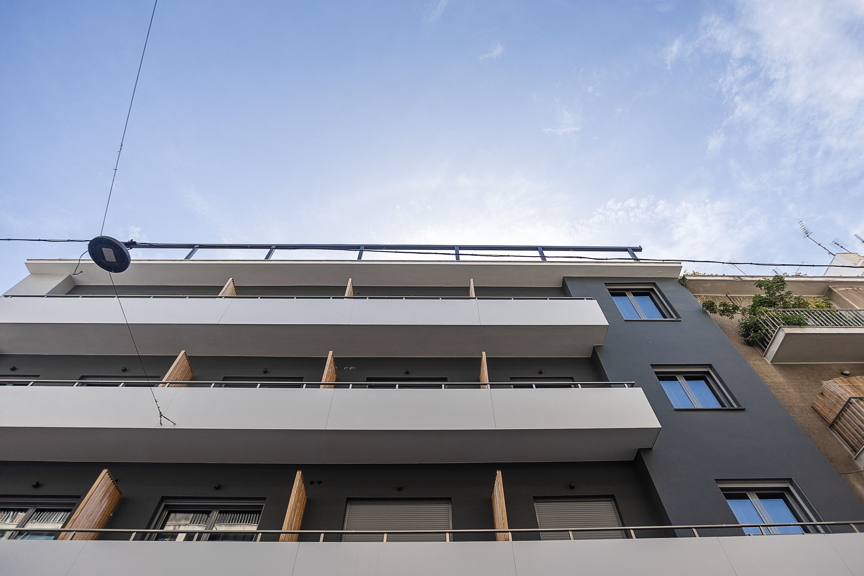 A multi-story building with balconies and windows.