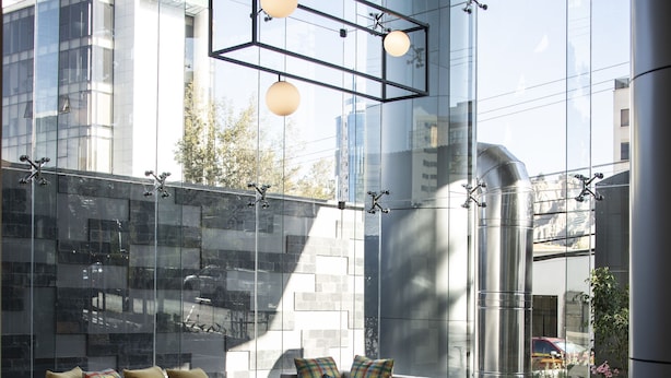 A modern lounge with a sofa, chairs, and a coffee table.