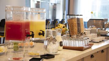 A breakfast buffet with various food items and beverages.