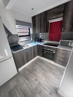 Family Apartment, 1 Bedroom | Private kitchen | Fridge, microwave, electric kettle, toaster