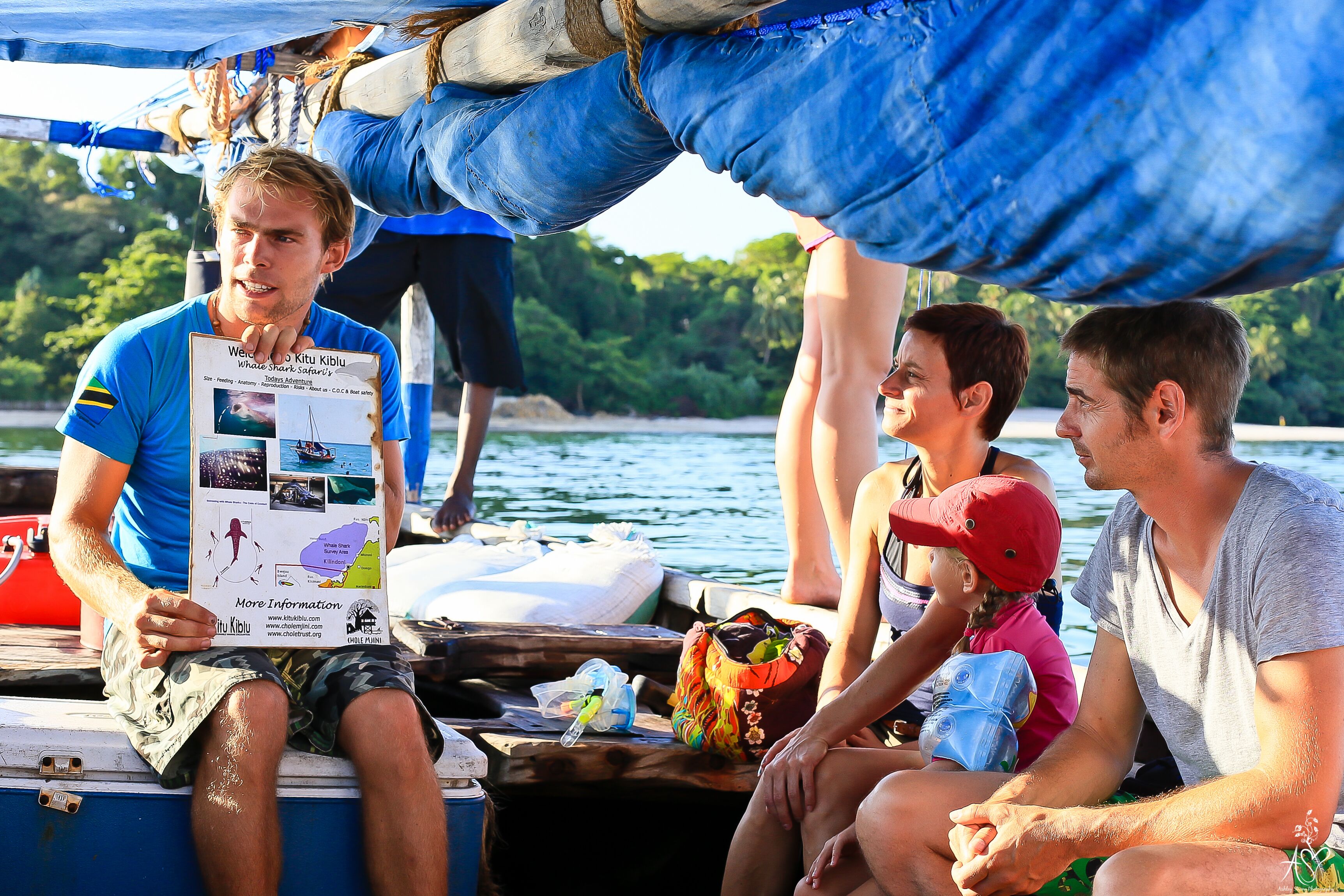 A group of people on a boat with a map and information booklet.