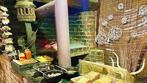 A kitchen with various food items, utensils, and a bread basket. - Roy's Rest Camp (Grootfontein)