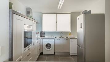Deluxe Apartment, 3 Bedrooms | Private kitchen | Full-sized fridge, microwave, oven, stovetop