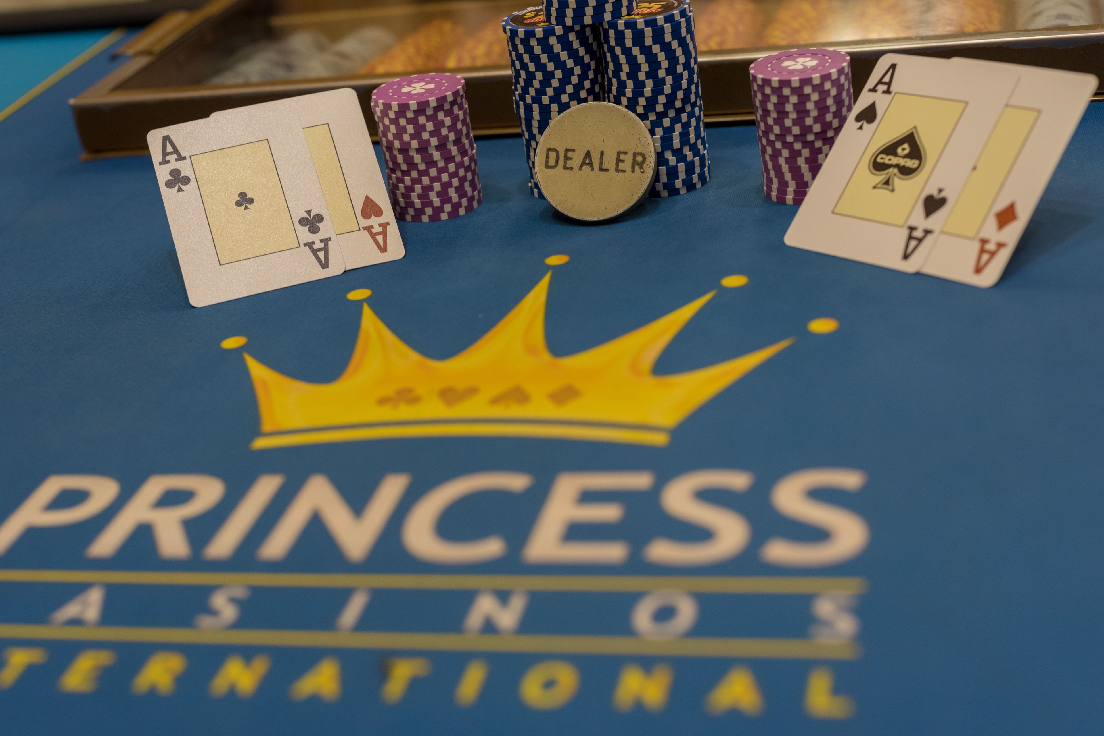 A casino table with playing cards and poker chips.