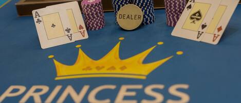 A casino table with playing cards and poker chips.