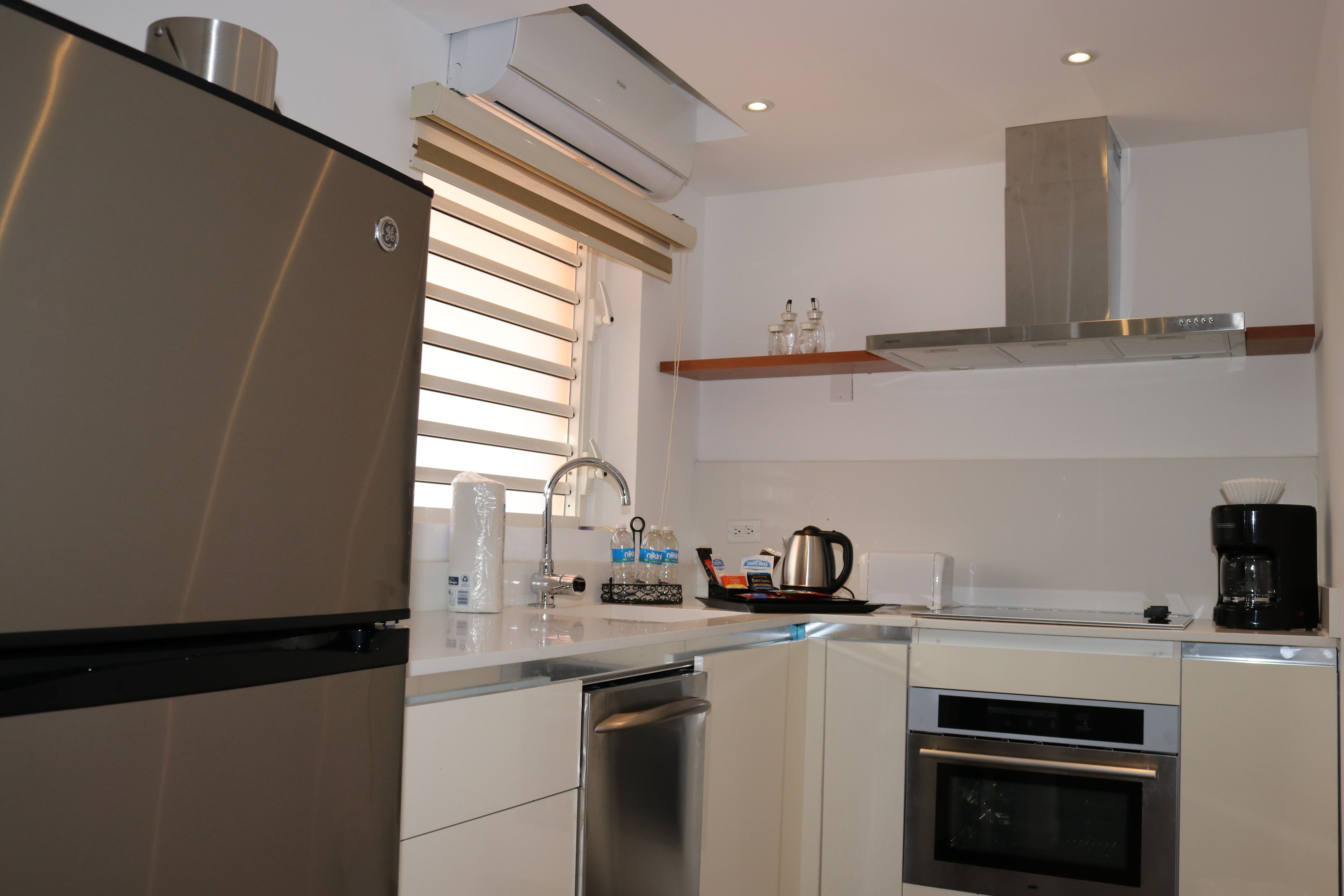 A modern kitchen with stainless steel appliances, a dishwasher, and a coffee maker.