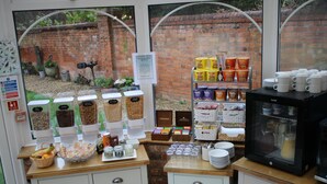 A breakfast bar with various food items and a coffee machine. - St. Margaret's Hotel (Oxford)