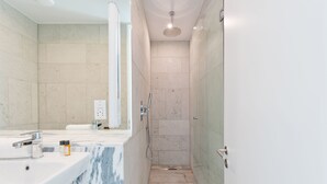 A modern bathroom with a marble sink, a handheld showerhead, and a glass-enclosed shower. - Double Penthouse en suite - hiphipstay (Dublin)