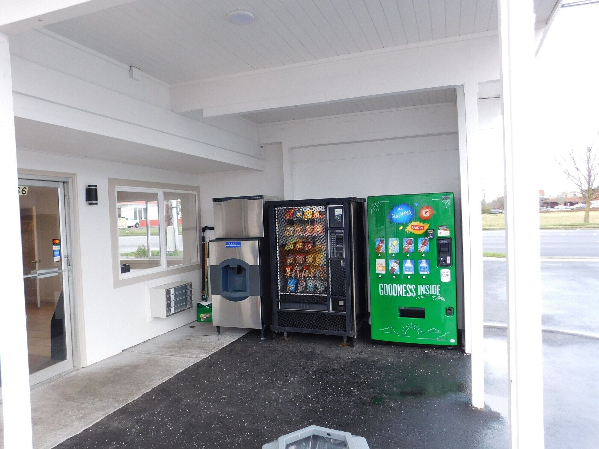 A building entrance with a vending machine and a water cooler.