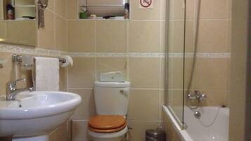 A bathroom with a sink, toilet, and bathtub.