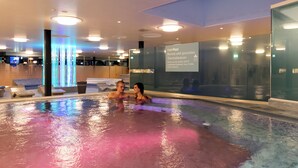 A hot pool area with a glass wall and a sign indicating the water temperature and duration of use. - Dorint Parkhotel Bad Zurzach (Bad Zurzach)