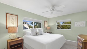 A bedroom with a bed, nightstands, a ceiling fan, and windows with blinds. - Naples Lake House. Bike to Beach. Pet Friendly (Naples)