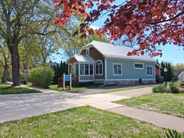 A single-story house with a porch, a covered front porch area, and a small front yard.
