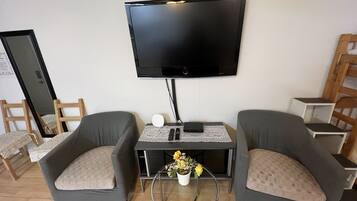 Family Suite, 2 Bedrooms | Living area | Plasma TV, heated floors