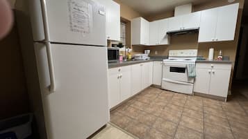 Comfort Suite, 2 Bedrooms | Private kitchen | Full-size fridge, microwave, toaster, cleaning supplies