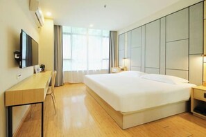 A hotel room with a large bed, a desk, a flat-screen TV, and a window with curtains. - Rest Motel (Xincheng Road) (WENZHOU)