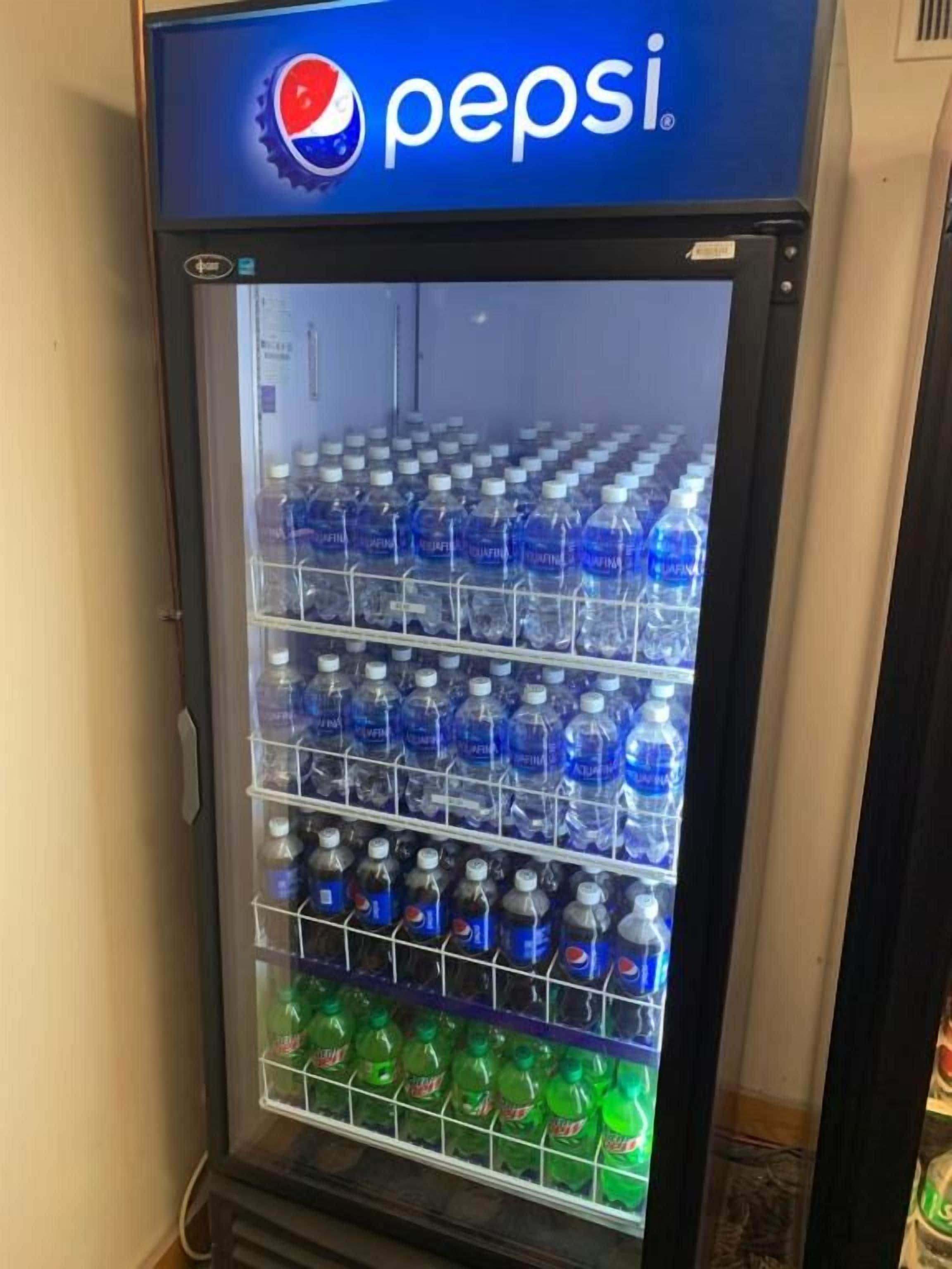 A vending machine with multiple shelves stocked with bottled water.