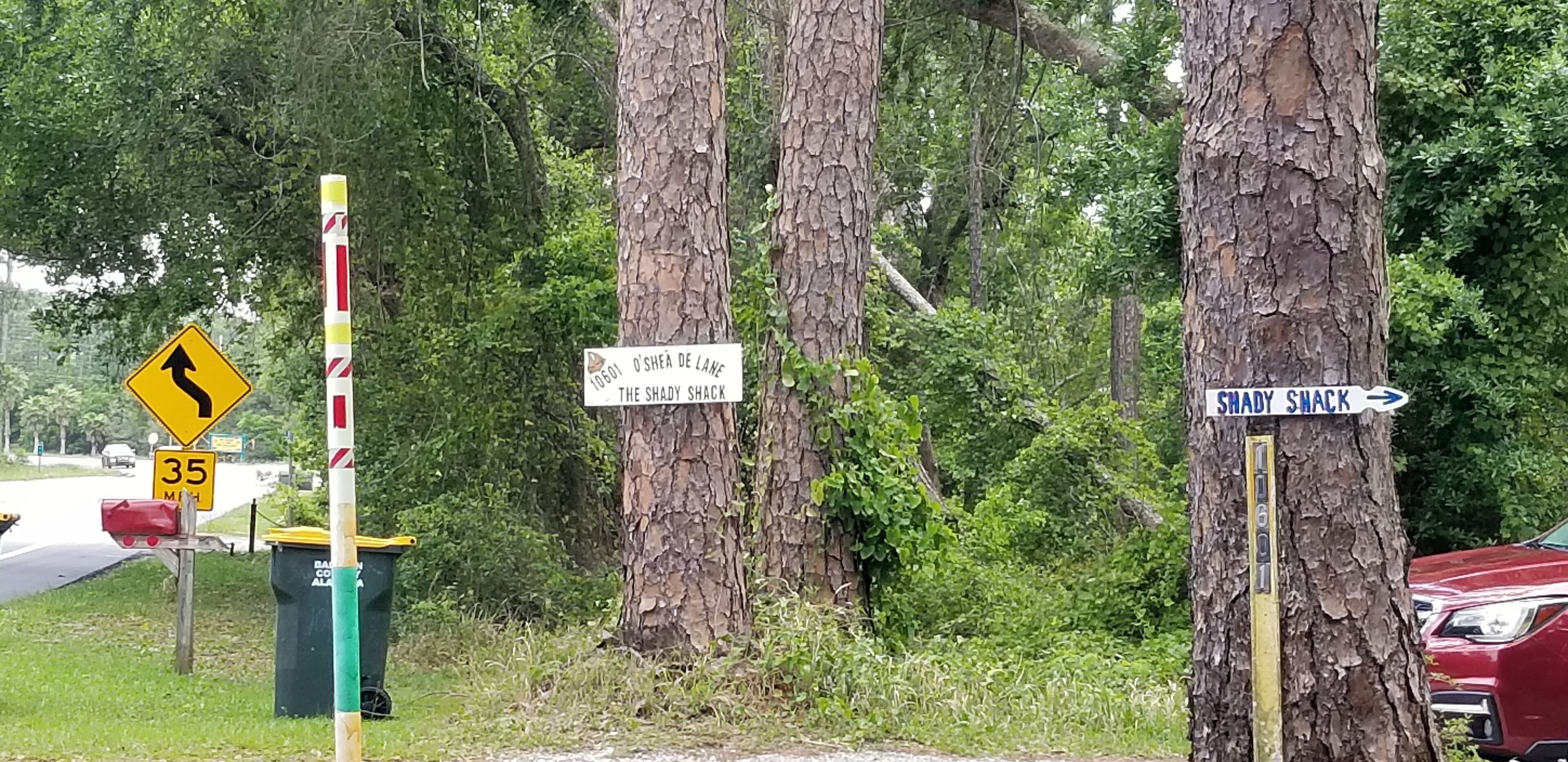 A road sign indicating a sharp turn ahead and a speed limit of 35 mph.