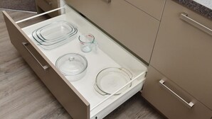 A kitchen drawer with clear glass containers and a measuring cup. - Room to spread out · fenced lawn, pets welcome - Weston Villa (St Albans)