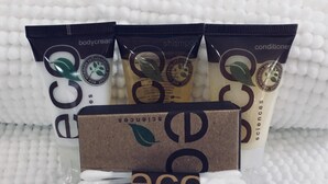A set of eco-friendly personal care products including body cream, shampoo, conditioner, and a vanity kit, all packaged in eco-conscious branding. - Mountain Time | Scenic Views, Hot Tub, Wi-Fi, & Shuffleboard (Bryson City)