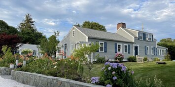 Main house, a garden of many hydrangeas and a very well manicured yard