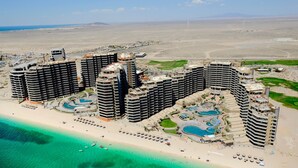 A coastal hotel complex with multiple high-rise buildings, a beach, and a pool area. - 2 Kings plus Bunk Bed Room 3rd floor Huge Patio (Puerto Penasco)