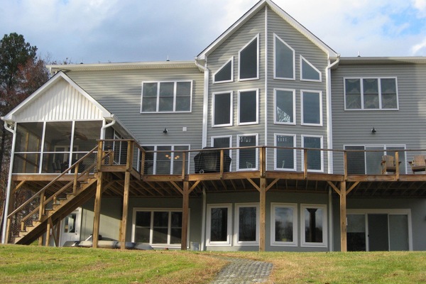 Back of house with path to lake