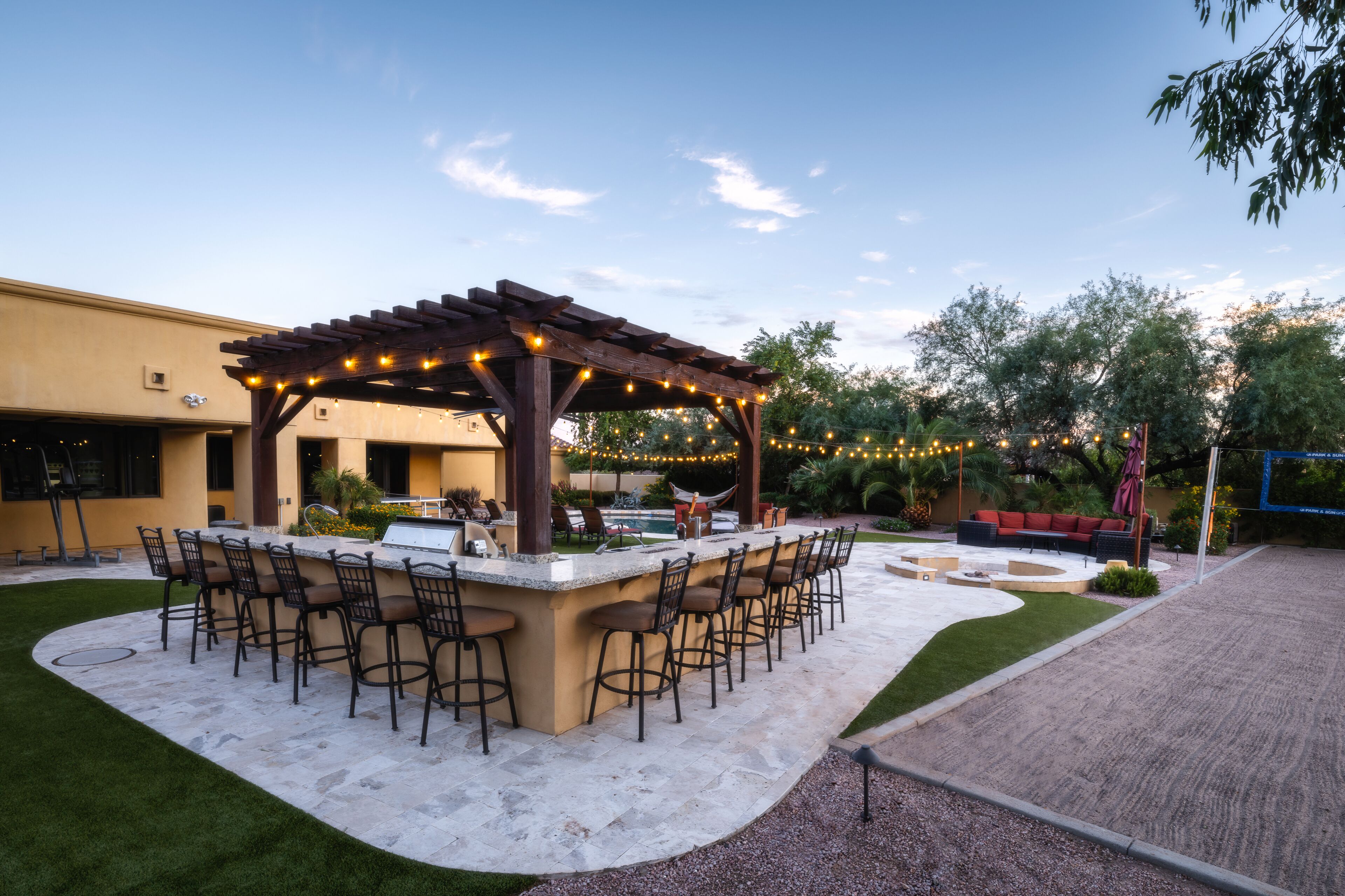 Outdoor kitchen and volleyball court.