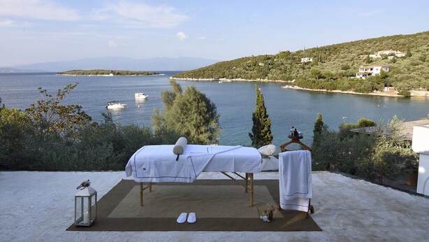 A massage table set up on a terrace overlooking a body of water with boats, trees, and houses in the background. - Beach Front, Romantic Escape, Breathtaking Views, 'Pieds dans L'eau', & More (Magnesia)