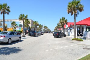 A street lined with palm trees and parked cars. - #101 Ocean Inn 2 Bedroom 1.5 Bath Modern Favorite (Isle of Palms)