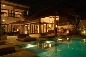 An infinity pool, sun loungers