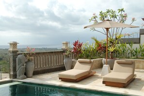 An infinity pool, sun loungers