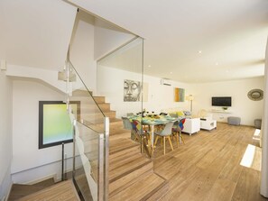 A modern interior with a staircase, dining area, and living space. - Villa Jade I· Villa with private pool in Can Picafort (Can Picafort)