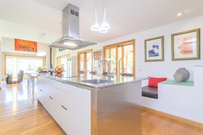 Enjoy cooking in this well-lit kitchen with a central island and stainless steel sink.