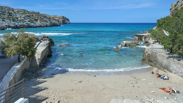 A coastal beach with clear blue waters, rocky cliffs, and a stone staircase leading down to the shore. - VILLA  BOBIS - RUSTIC STAY (Pollensa)