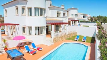 A heated pool, sun loungers