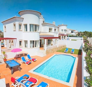 A heated pool, sun loungers