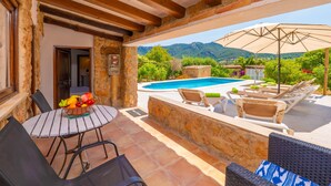 A patio with a pool, outdoor seating, and a view of mountains. - CASA MARGARITA - Villa with private pool and free WiFi (Andratx)