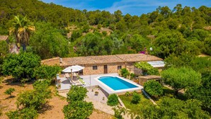 A villa with a swimming pool, surrounded by lush greenery and a hilly landscape. - CASA MARGARITA - Villa with private pool and free WiFi (Andratx)