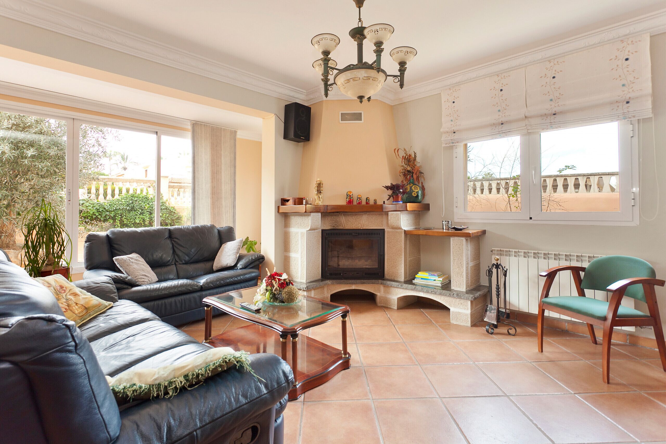 A living room with a fireplace, a sofa, a chair, and a coffee table.