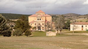 A church with a central dome and bell tower, surrounded by open fields and sparse trees. - House (full rental) Entre Hoces for 10-12 people (Campo de San Pedro)