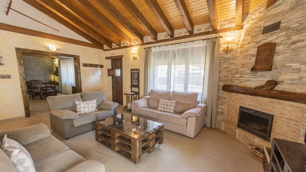A cozy living room with two sofas, a coffee table, and a fireplace. - House (full rental) Entre Hoces for 10-12 people (Campo de San Pedro)