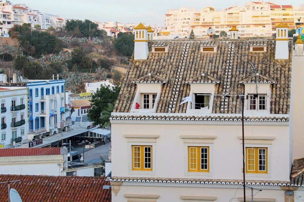 A building with a tiled roof and a balcony.