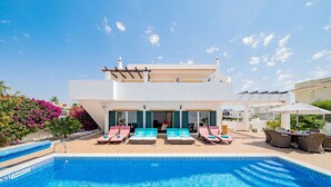 A modern villa with a swimming pool, outdoor seating, and a clear blue sky. - Modern villa near beach [83] (Lagos)
