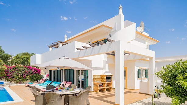 A white villa with a pool, outdoor seating, and a barbecue area. - Modern villa near beach [83] (Lagos)